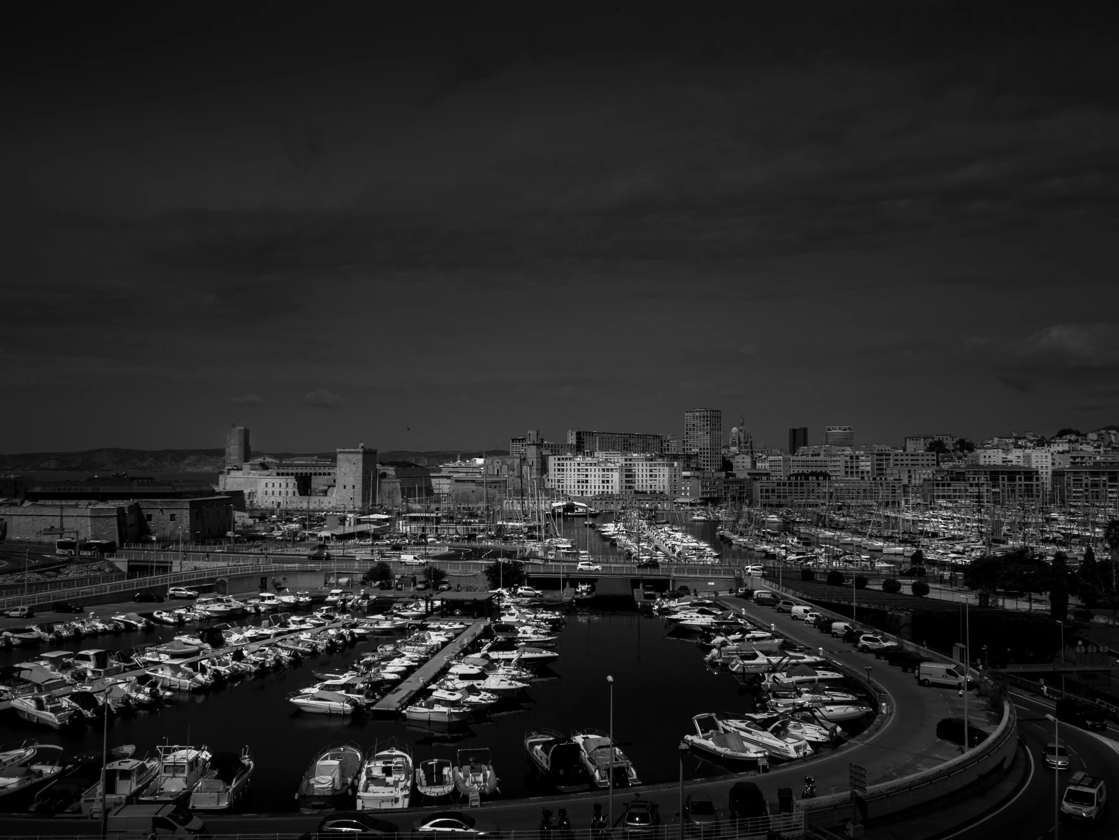 black and white pograph of city traffic with marina