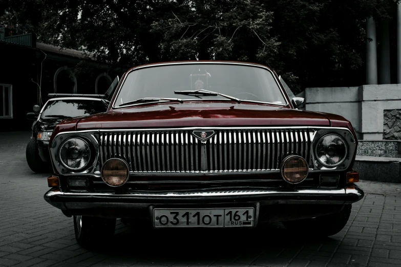 the front of a classic british car parked outside