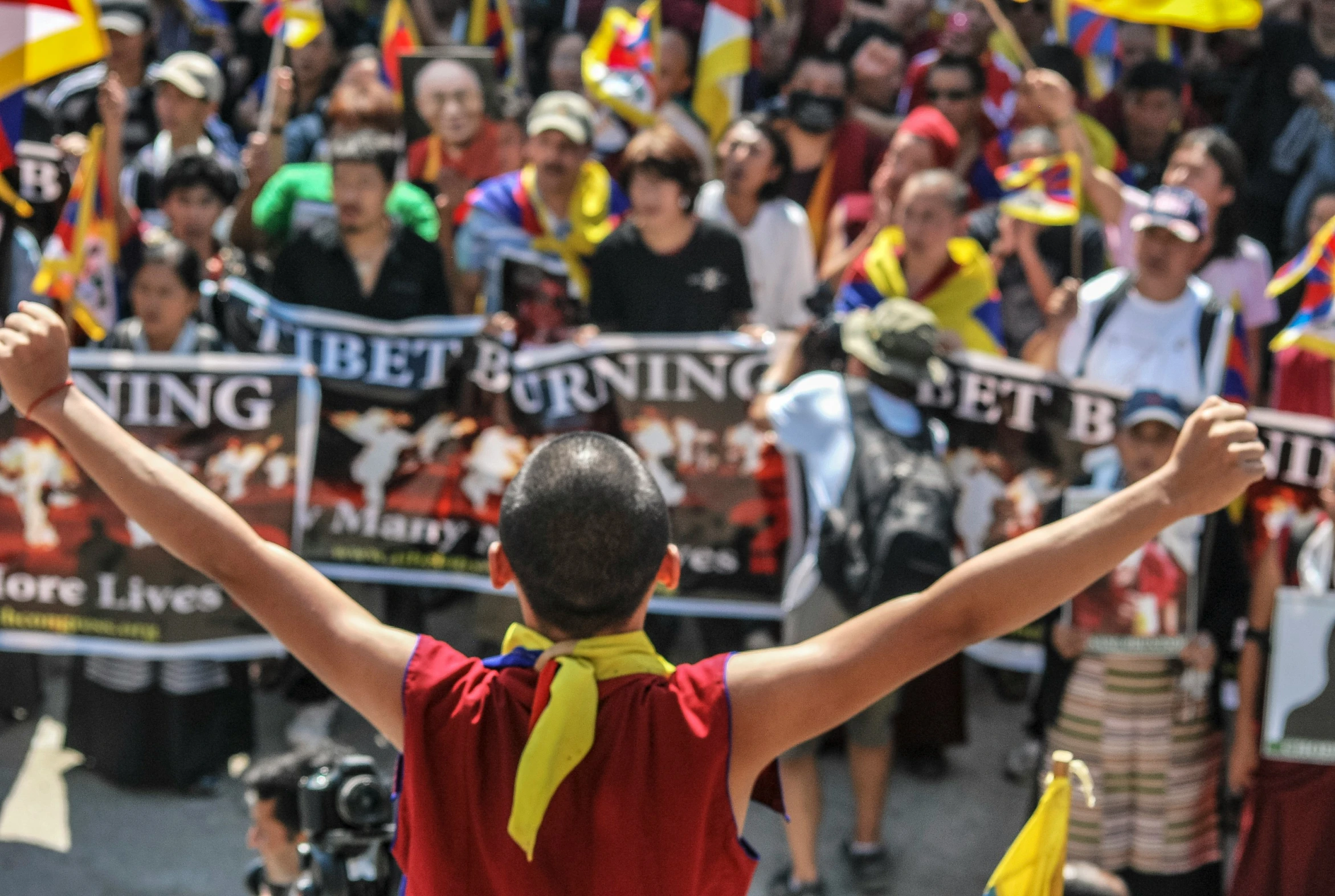 a boy raises his hands in celetion, while others look on