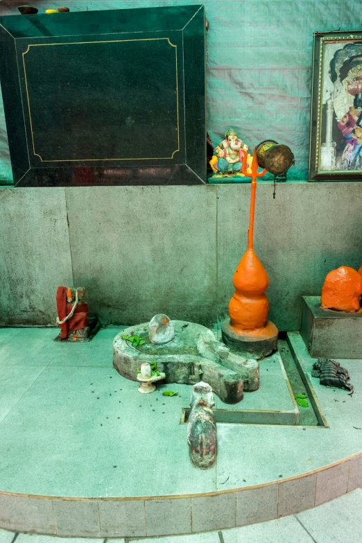 a room with several vases and a painting on the wall