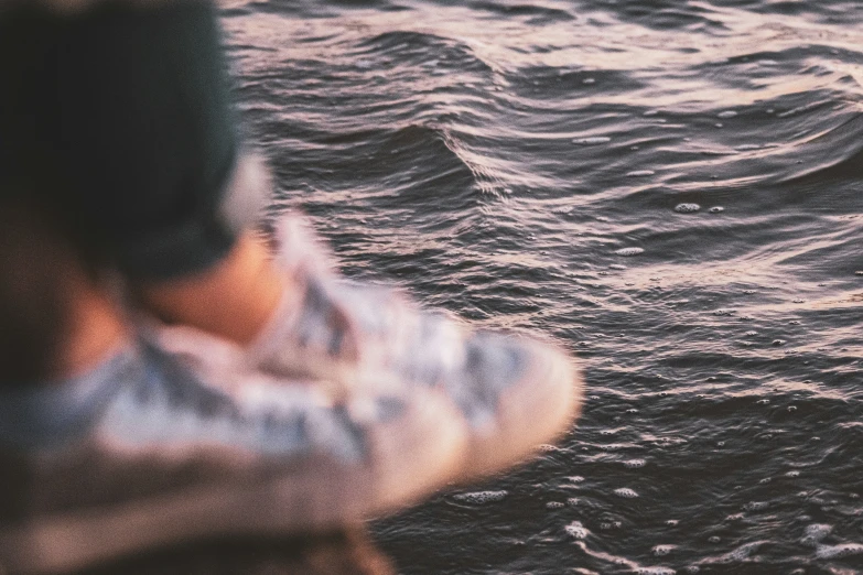 a person with a white jacket walking through water