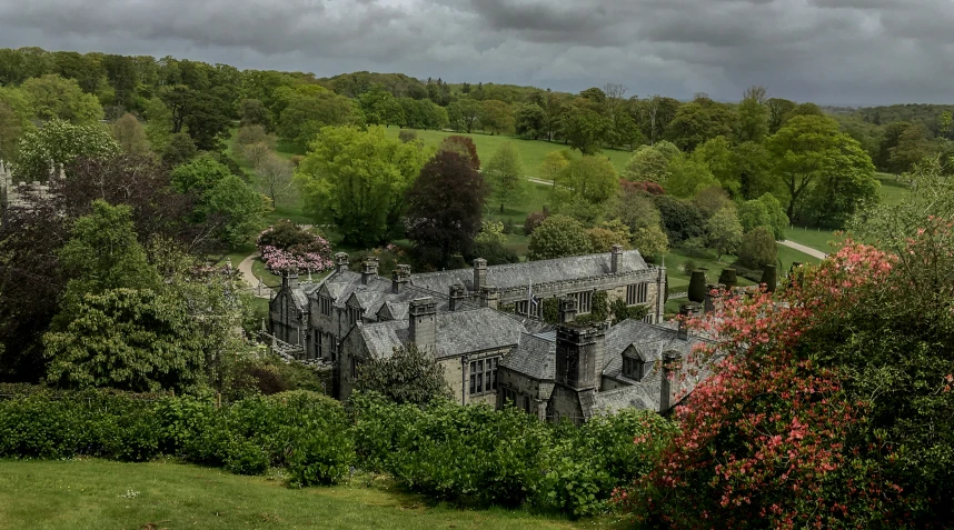 an old mansion surrounded by lush green trees