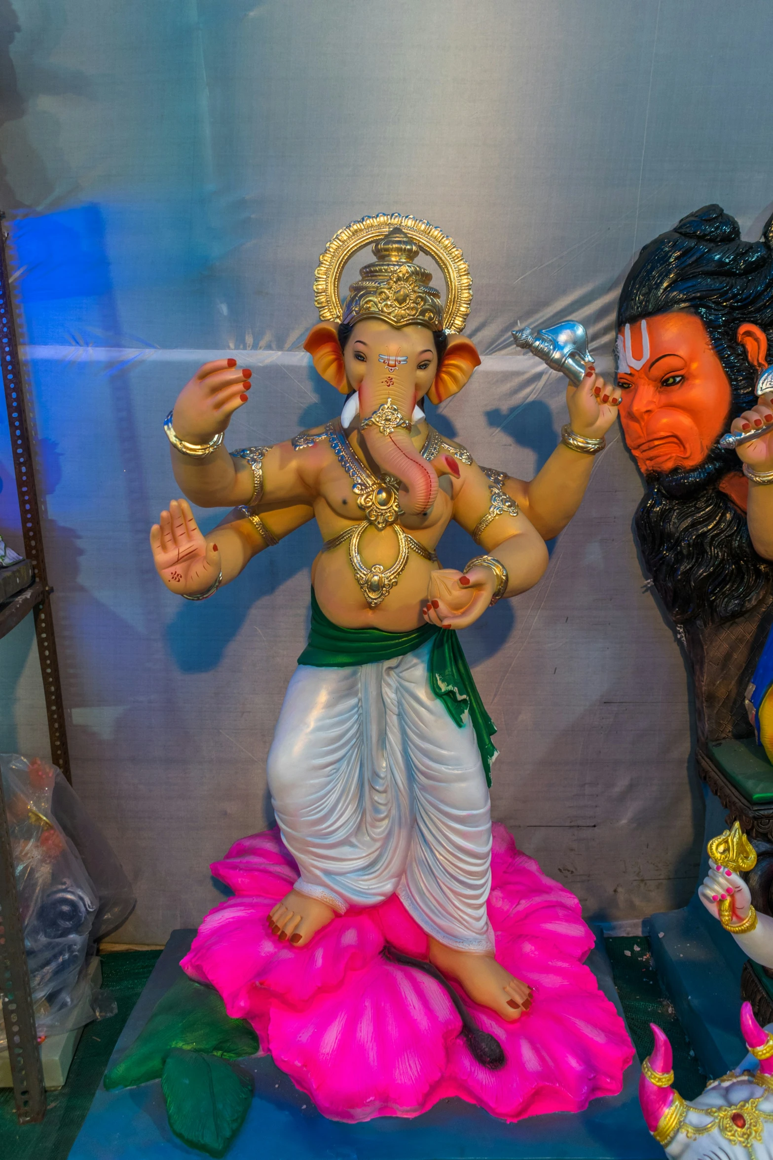 a statue is sitting near two statues on display