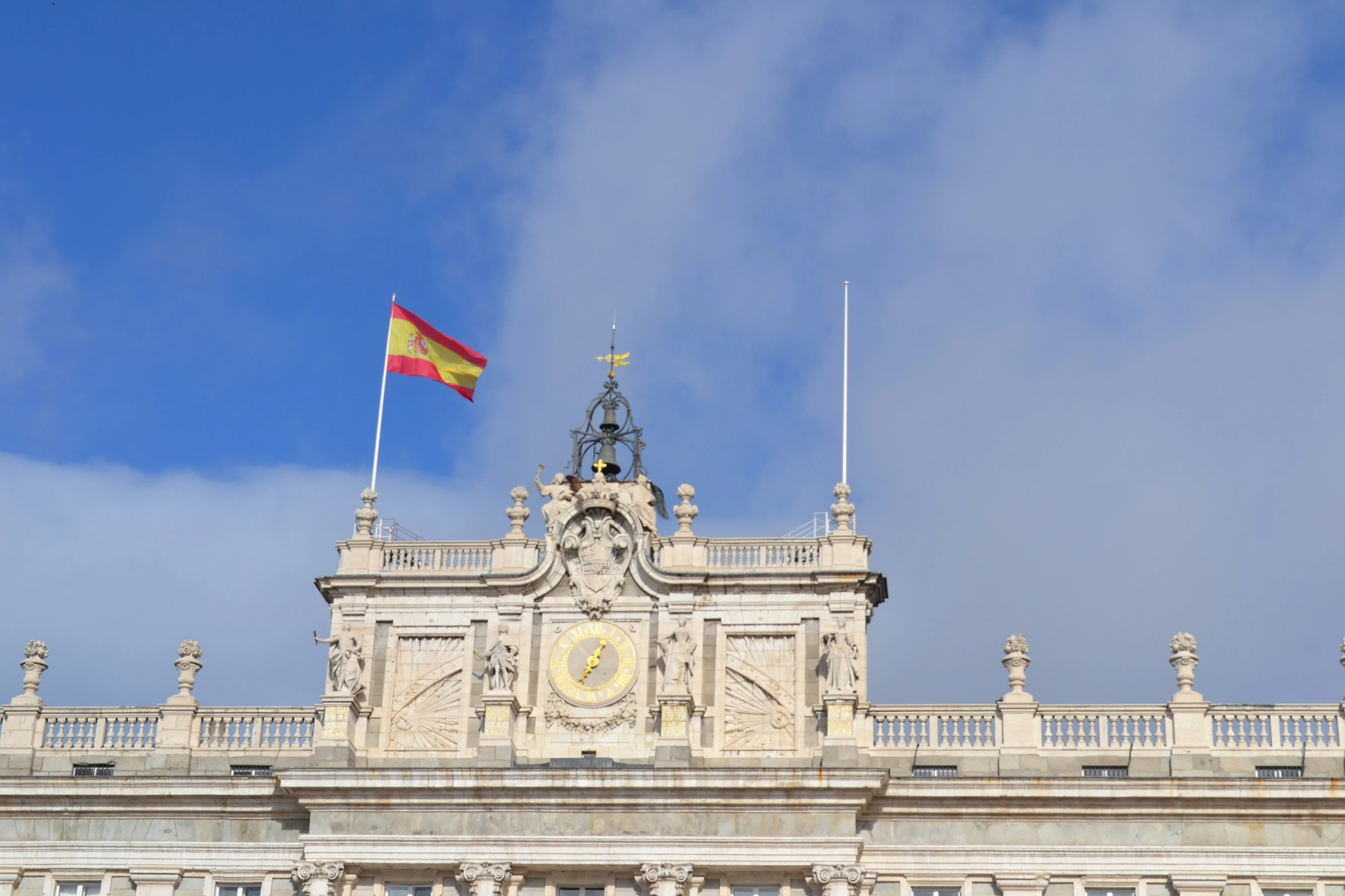 a large building with a clock and flag on top