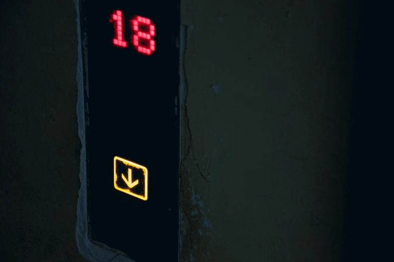 an electrical sign that is on a dark wall