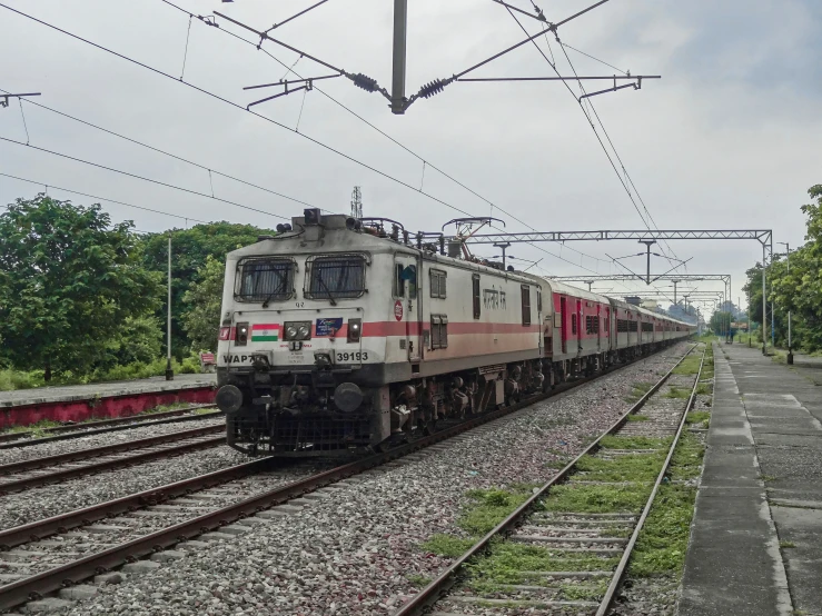 the train is approaching on its tracks near other tracks