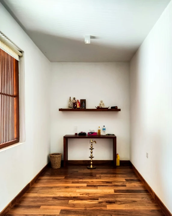 a small long hallway with wood floors and shelves