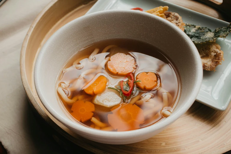 a white bowl filled with different types of food on top of a plate