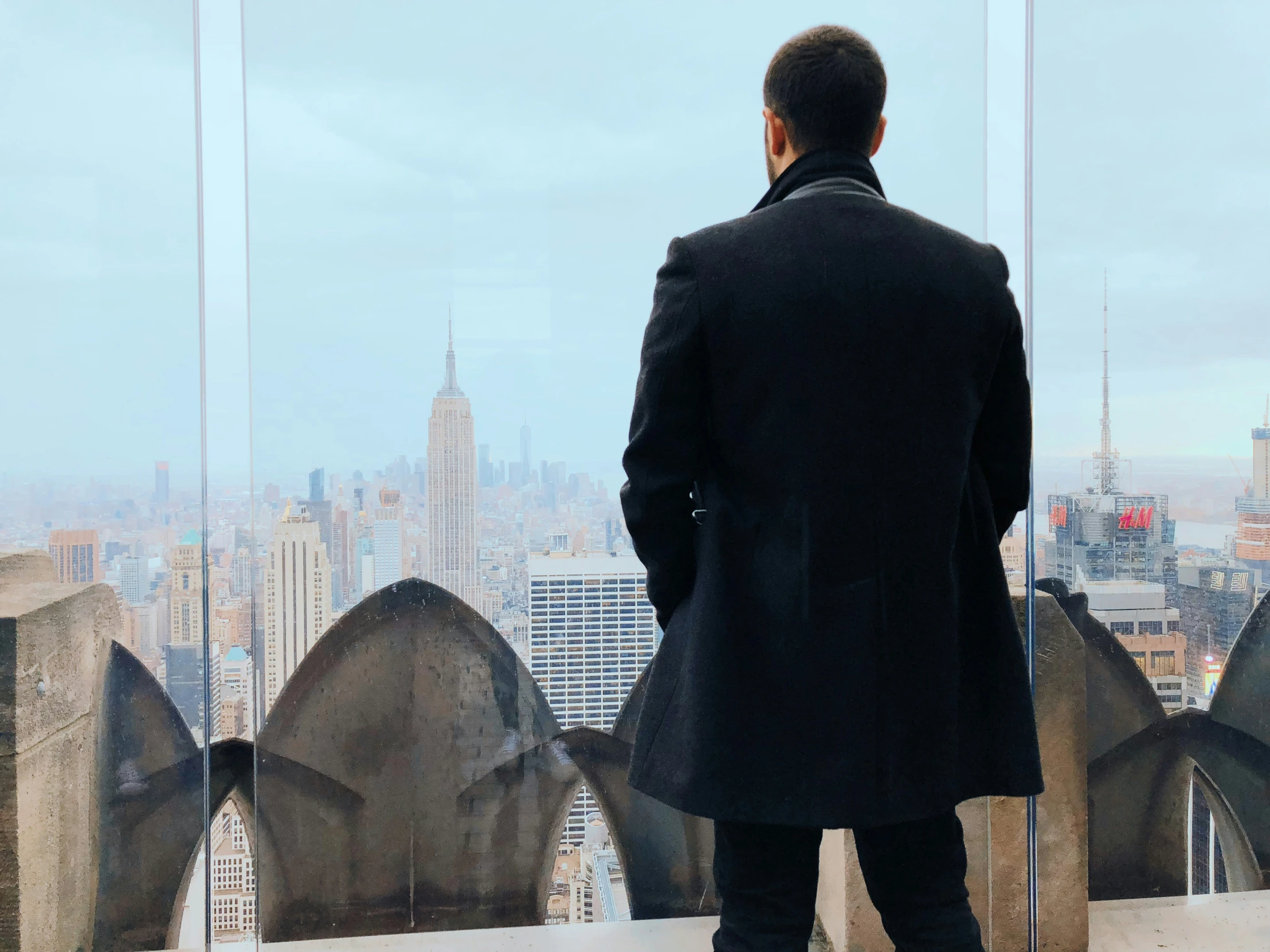 a man looking at the city from above