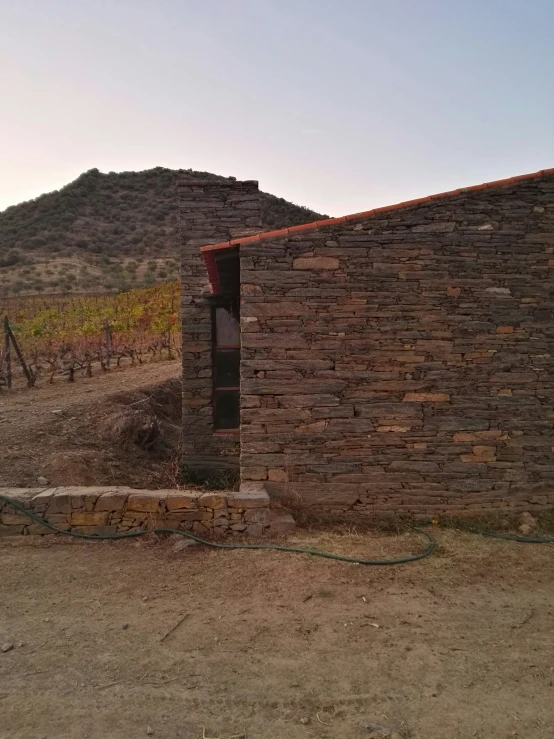 a house with a door sits near a winery