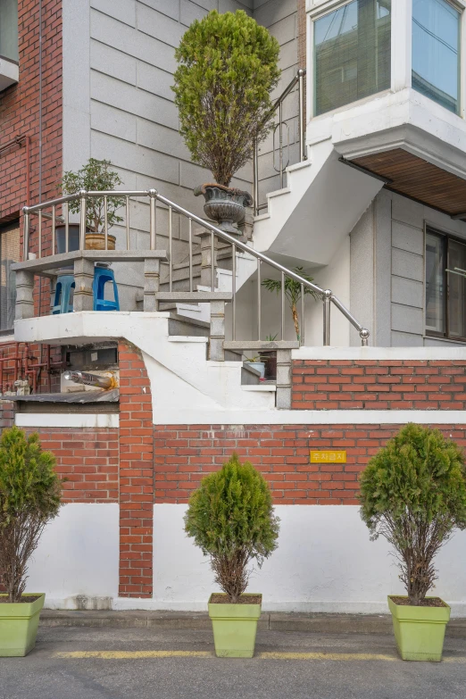 the stairs to an apartment complex are surrounded by hedges