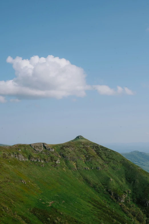 a green mountain in the country is in view