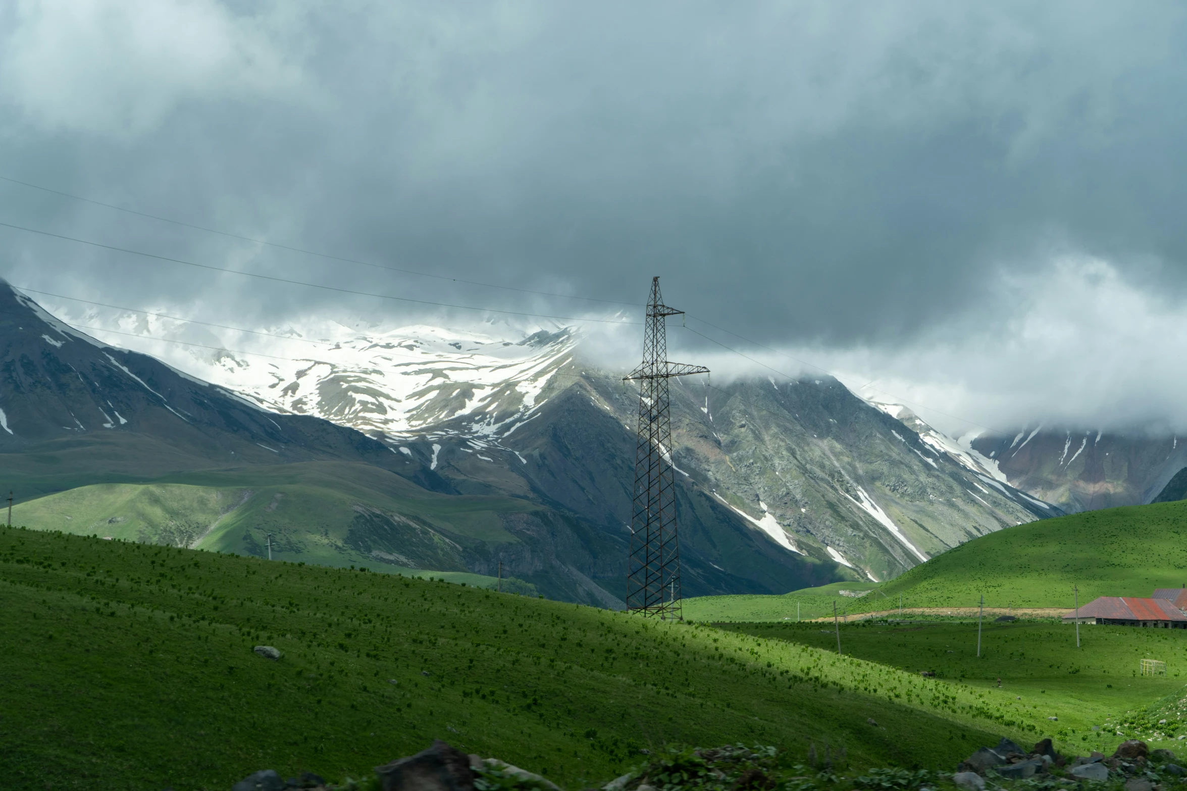 the mountains in the far distance have a field near it