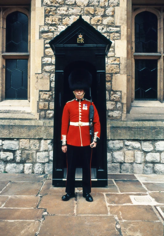 a guard stands in front of a doorway at castle