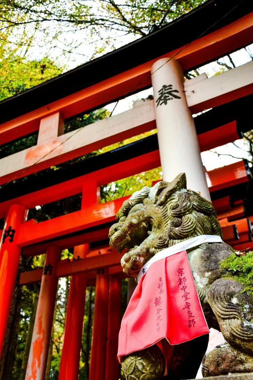 statue with writing on it at a small shrine