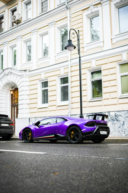 two cars parked next to each other in front of a building