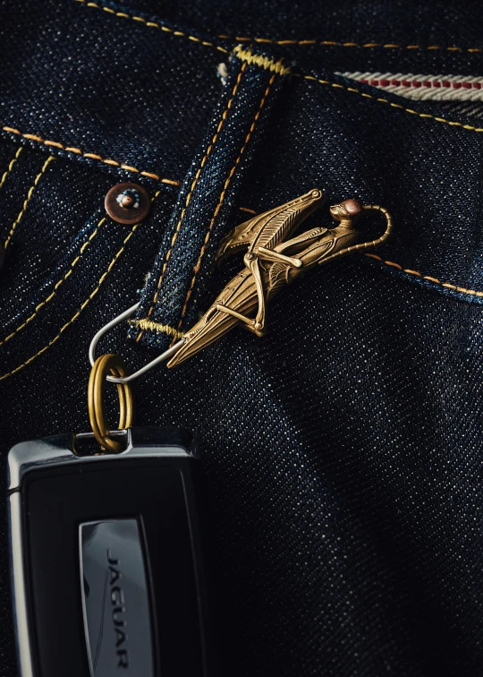 a cellphone hanging out the side of a pair of jeans