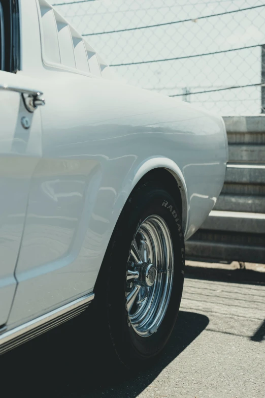 the rear end of an old white muscle car