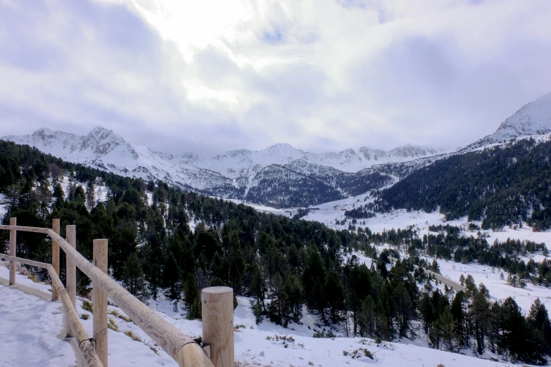 the snowy mountains are covered in snow and clouds