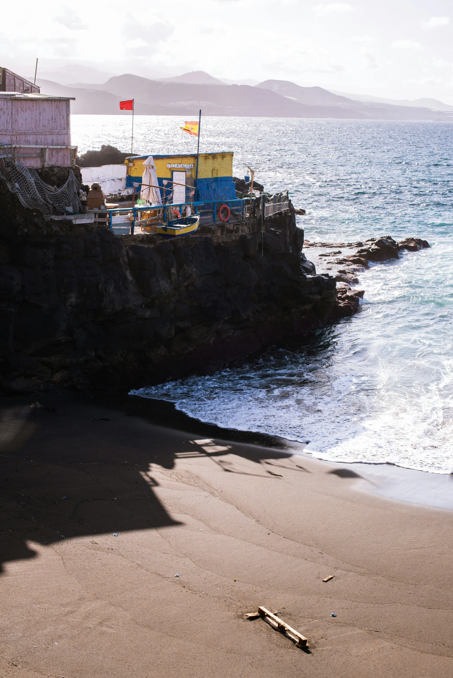 some kind of boat in the water on the shore