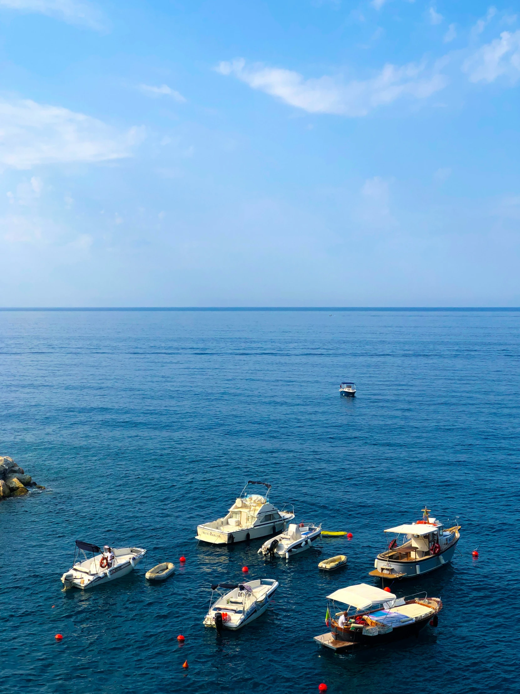 a group of small boats floating on top of the ocean