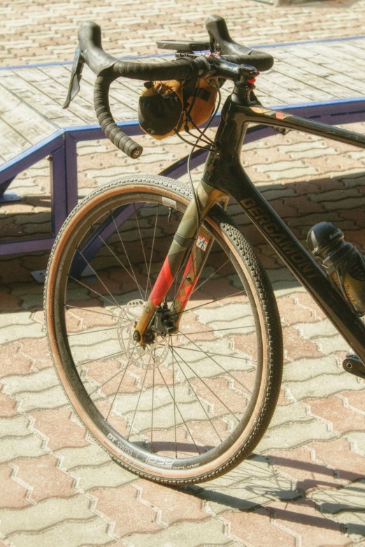 a bike leaning on a bench in the sun