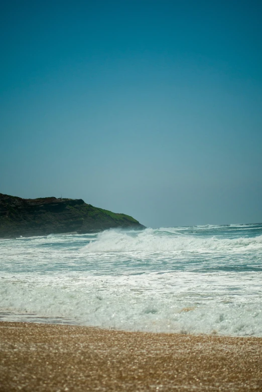 a surfer on a beach getting ready to ride a wave