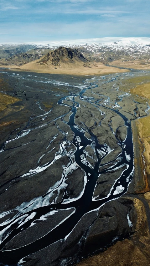 an aerial view of a long wide river in the valley