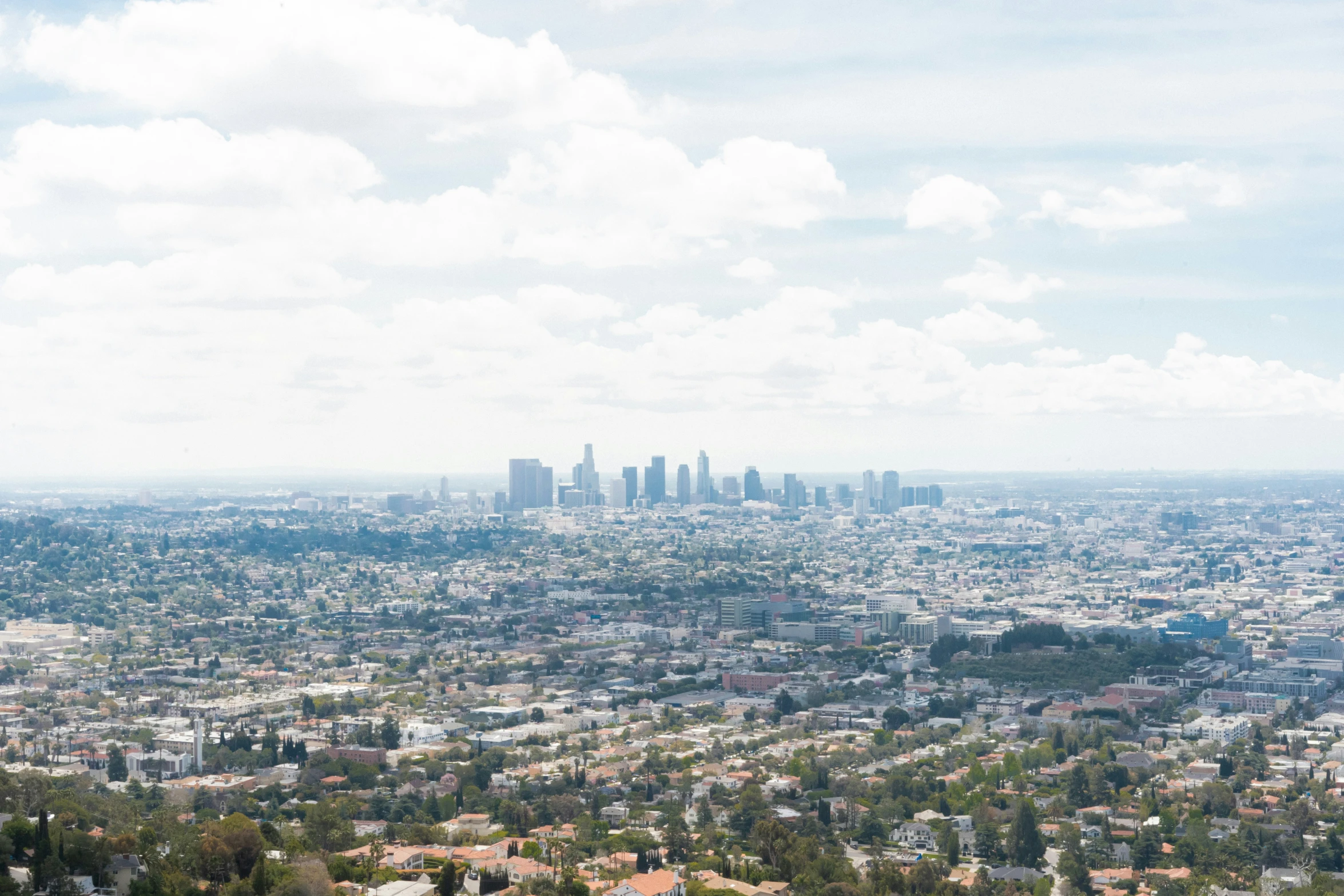 the city skyline is seen with skyscrs in the distance