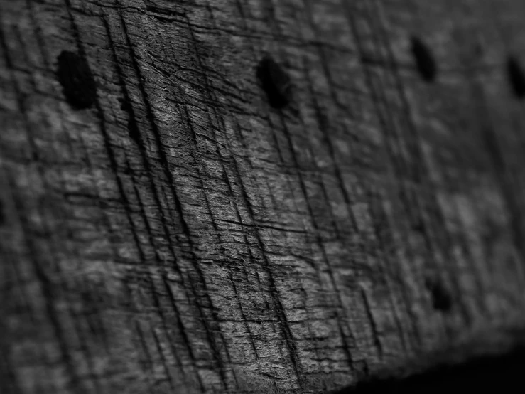 a wooden wall with some small holes in it