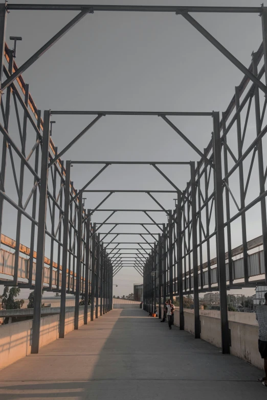 a long walkway lined with steel frames and posts