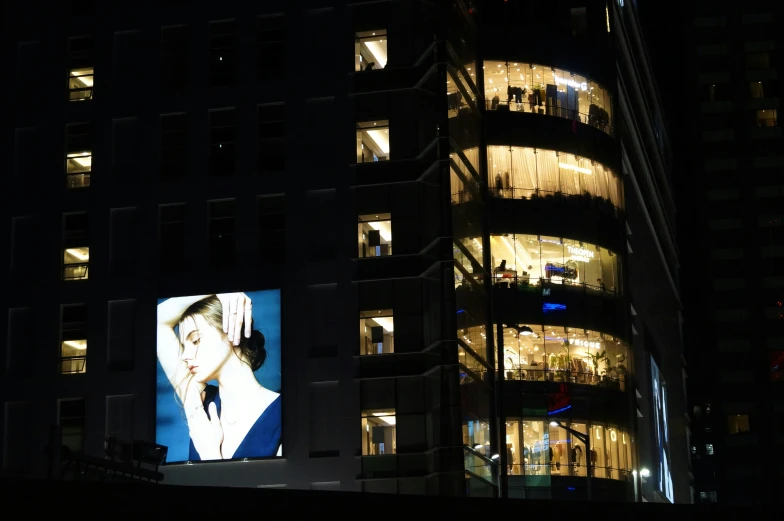 lighted window display in city at night with city view