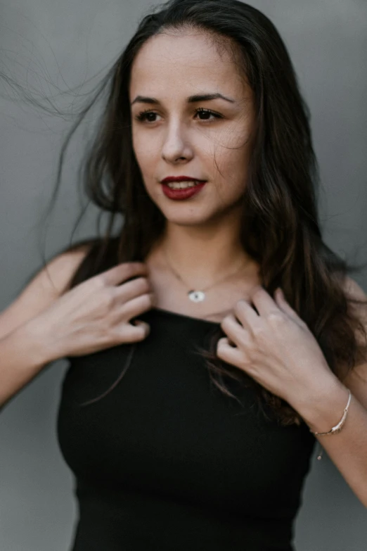 a woman in a black top with red lipstick