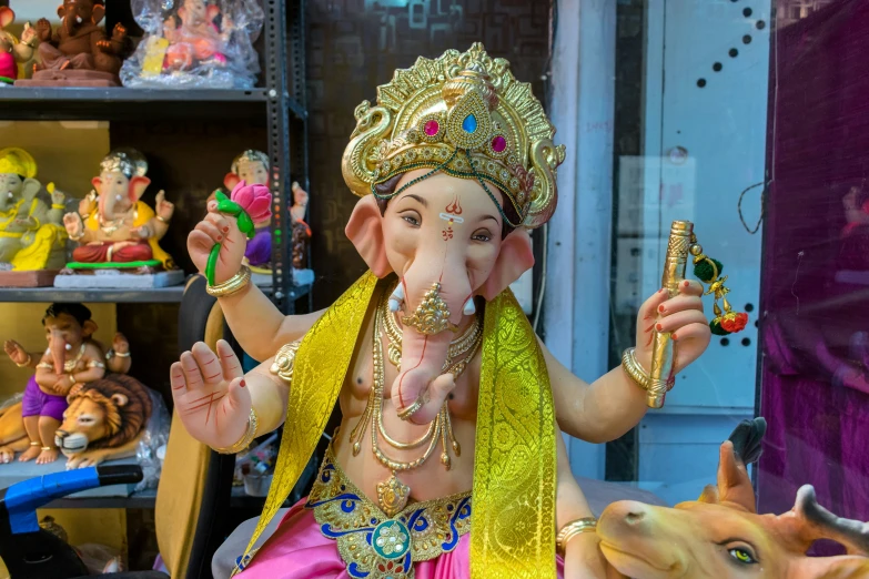 an idol of an elephant sitting in front of a display of toys