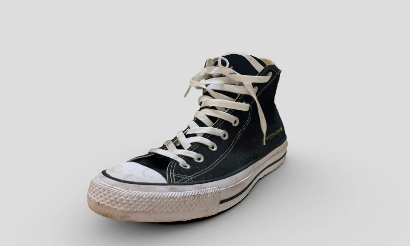 a black converse high top sneaker on a white background