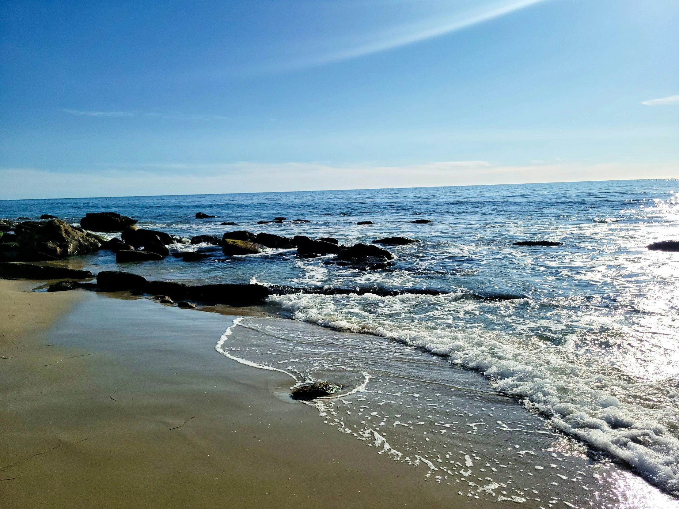 a large body of water near a sandy beach