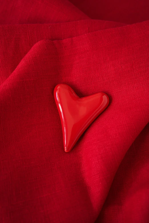 red heart on red fabric textured material