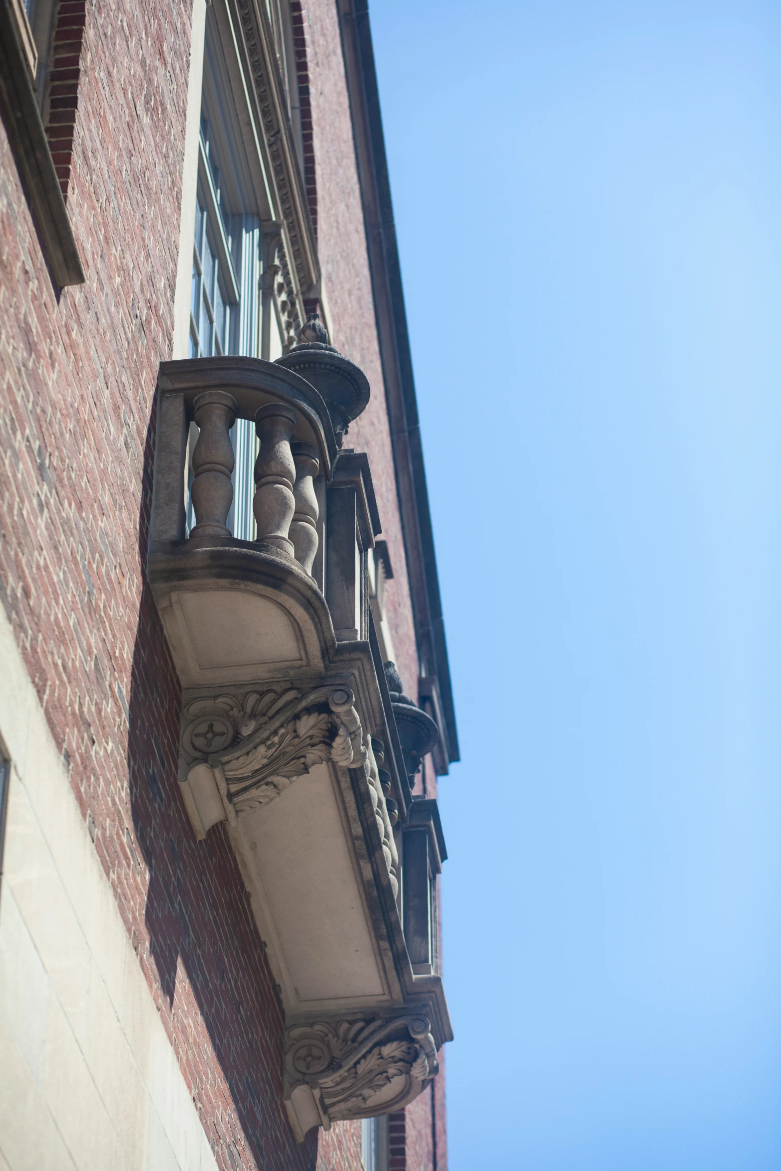 a balcony is attached to a red brick building