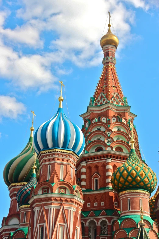 a tall cathedral with green and red domes