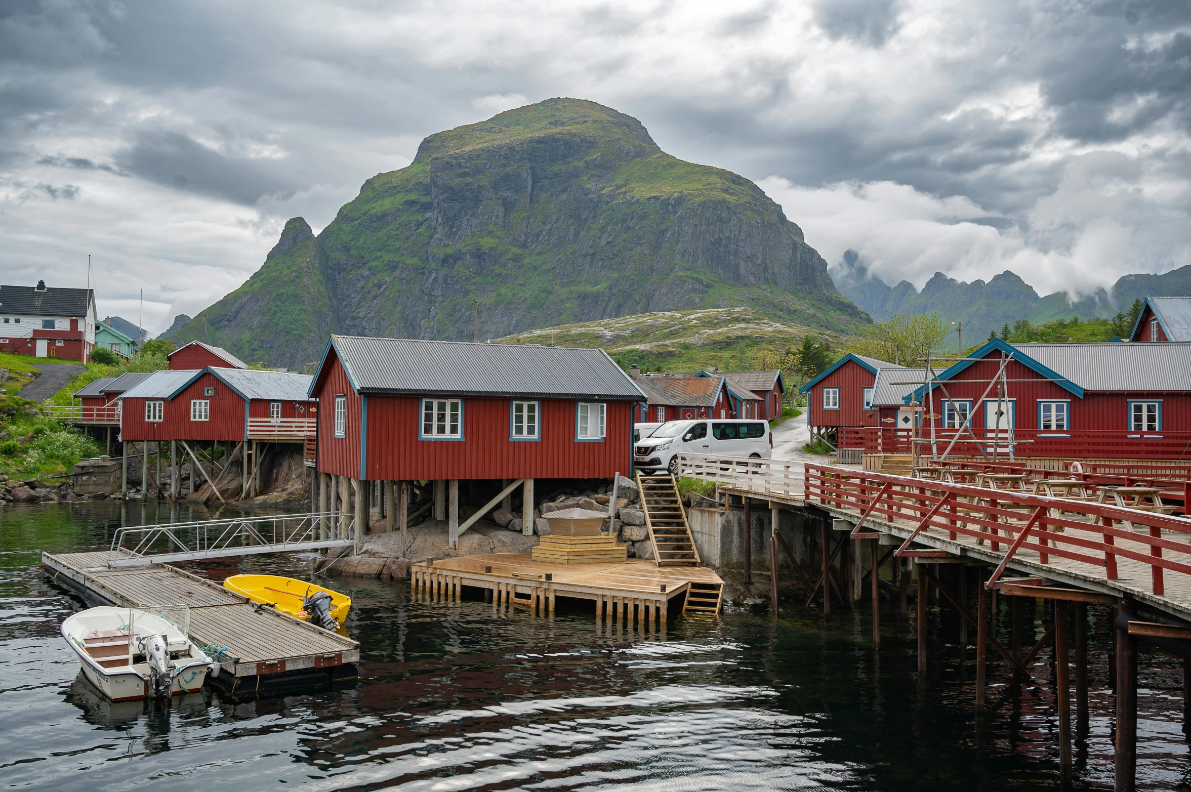 a bunch of wooden buildings and boats in the water