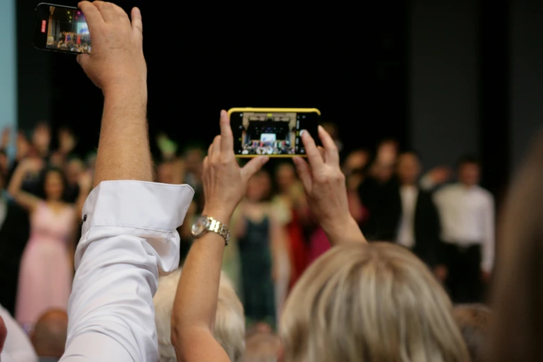 a person holding up a phone with their hands