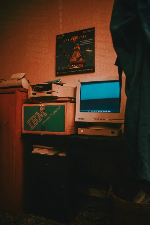 a computer desk with three monitors and a printer