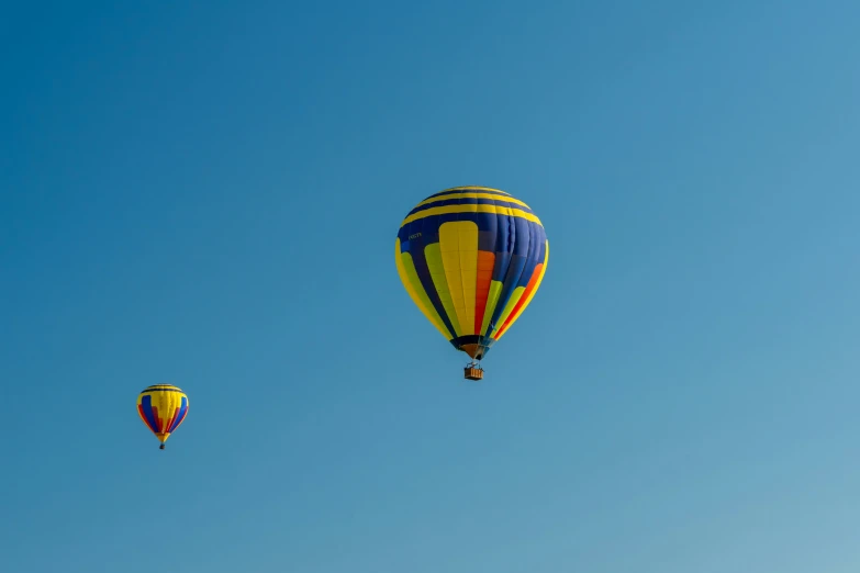 a couple of  air balloons flying in the sky