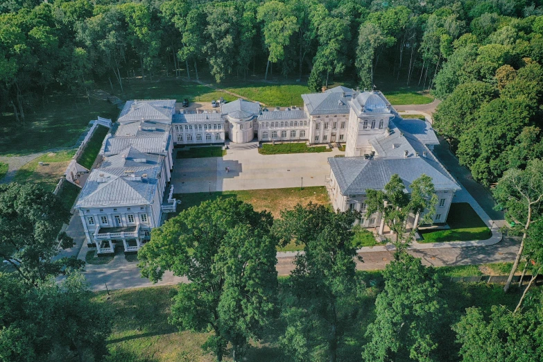 a large house with trees around it and many windows