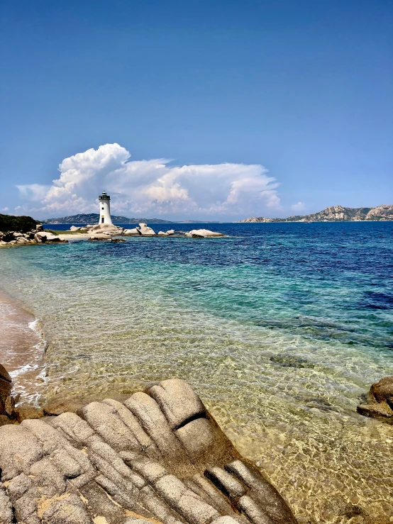 a light house on an island near the ocean