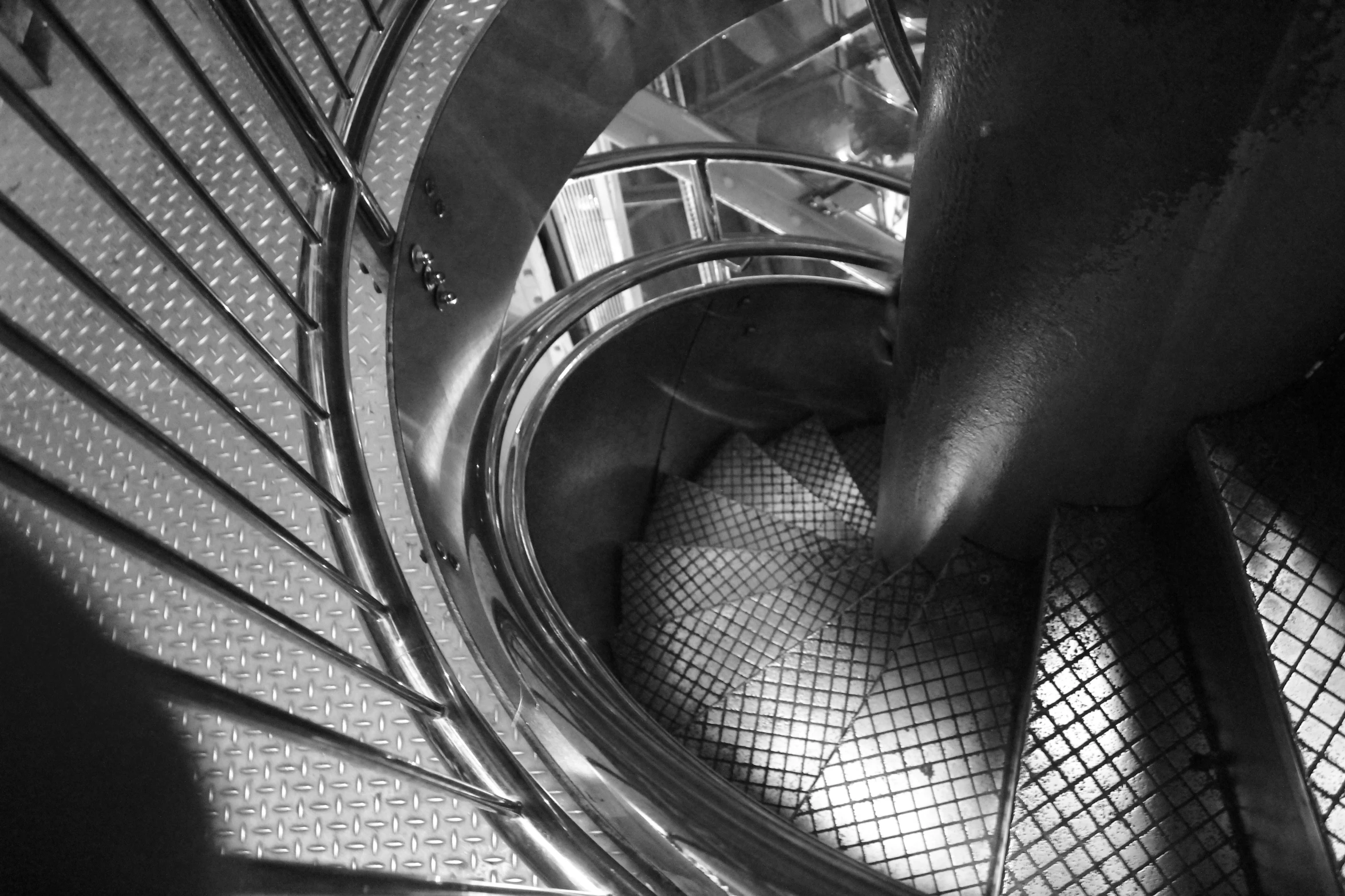 the spiral staircase with metal fencing is seen