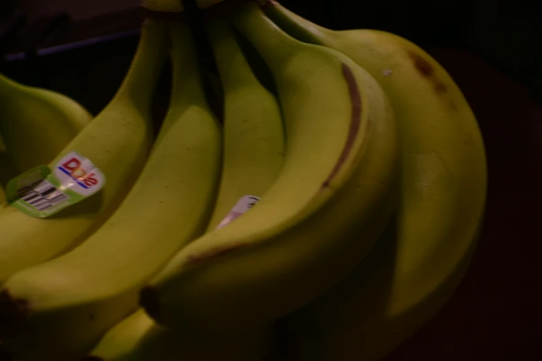 closeup of bunches of bananas with stickers on them