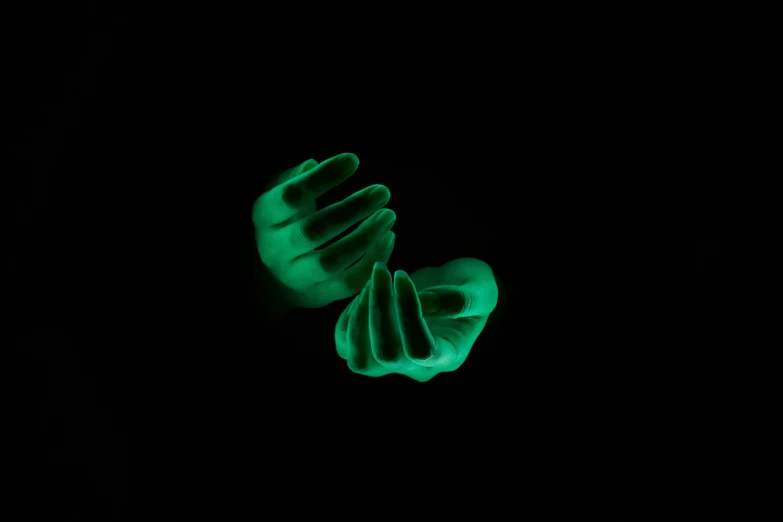 glowing hands on a black background glow in the dark