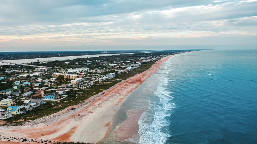 an overhead s of houses on a shoreline and beach