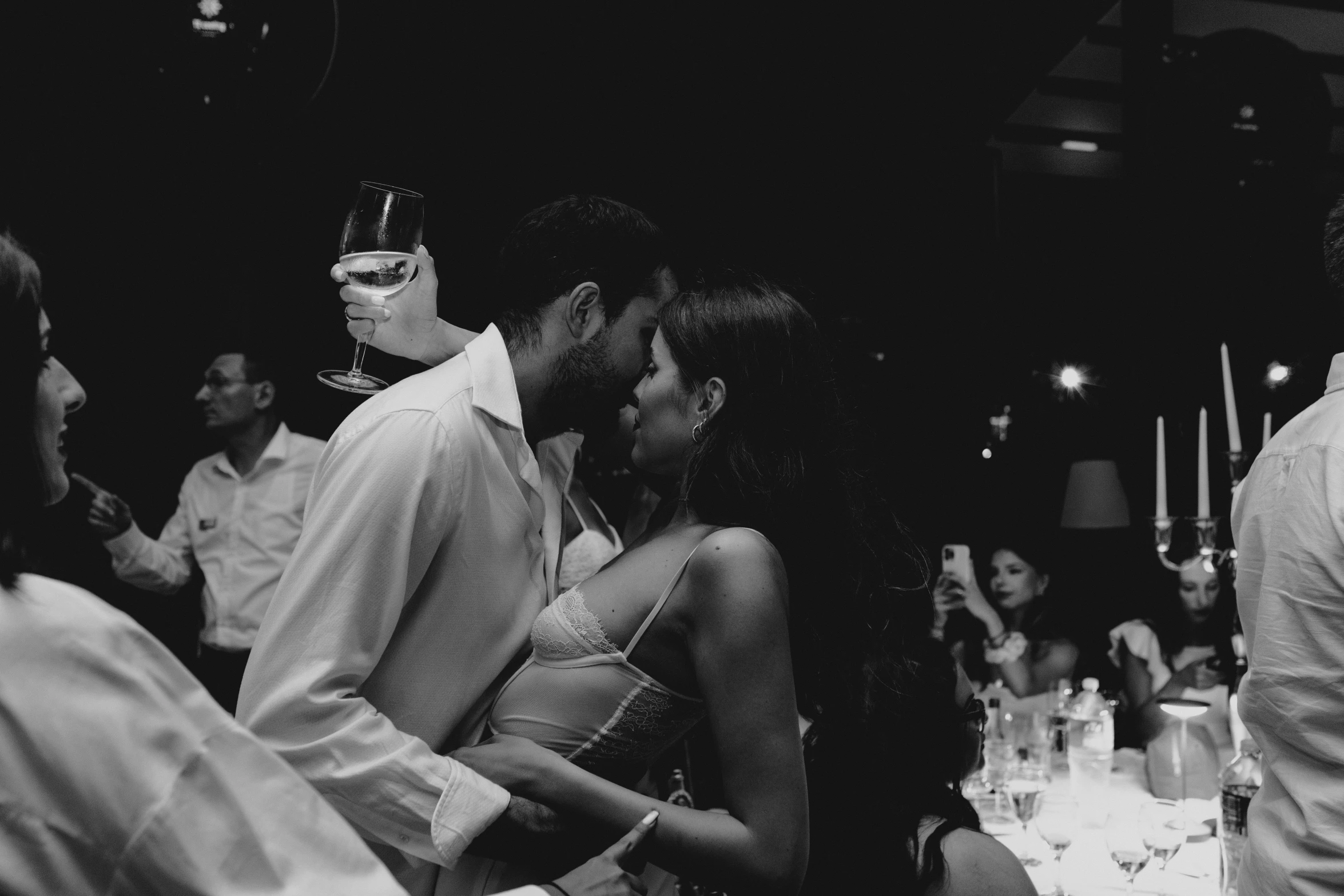 black and white pograph of a bride and groom kissing